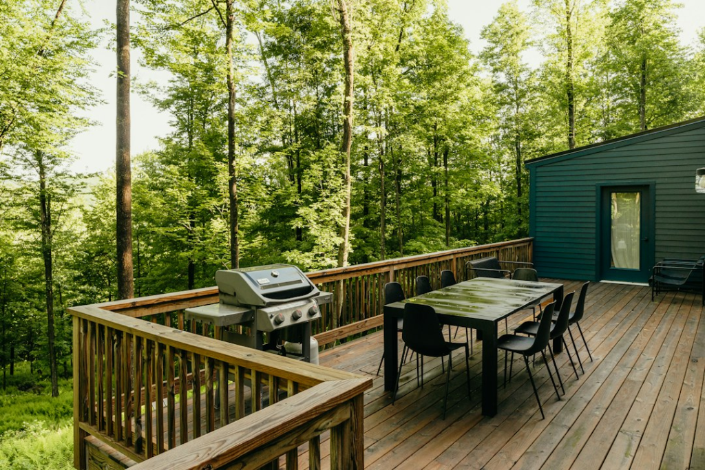 Outdoor wood deck with seating beside a home