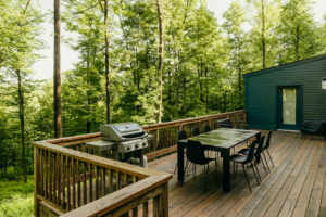 Outdoor wood deck with seating beside a home