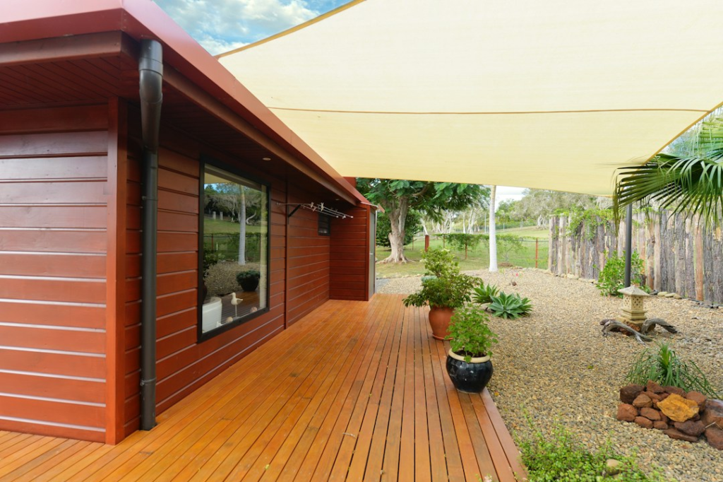 Wood deck and outdoor living area beside a modern home