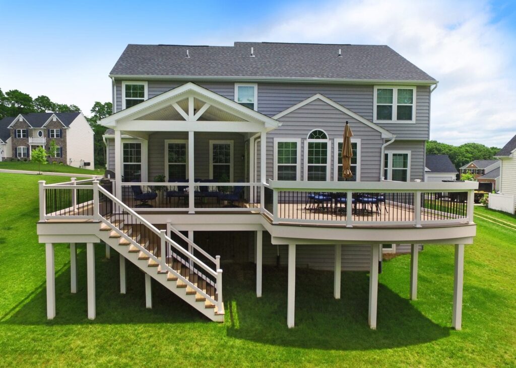 Multi-level deck connecting upper and lower outdoor living spaces