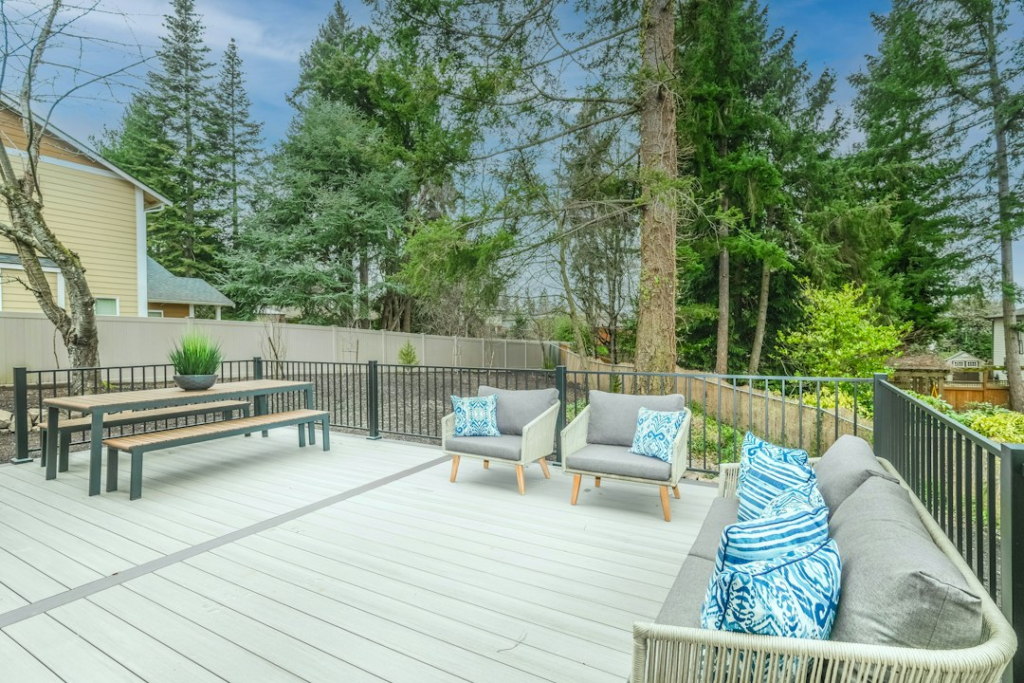 Finished backyard deck beside a modern home