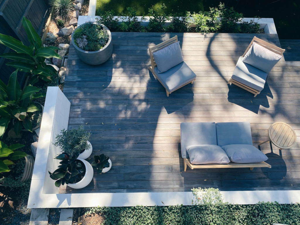 Composite-style outdoor deck with furniture and planters. Photo by Cameron Smith on Unsplash.