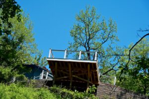 Elevated residential wood deck showing its support framing and cable railing
