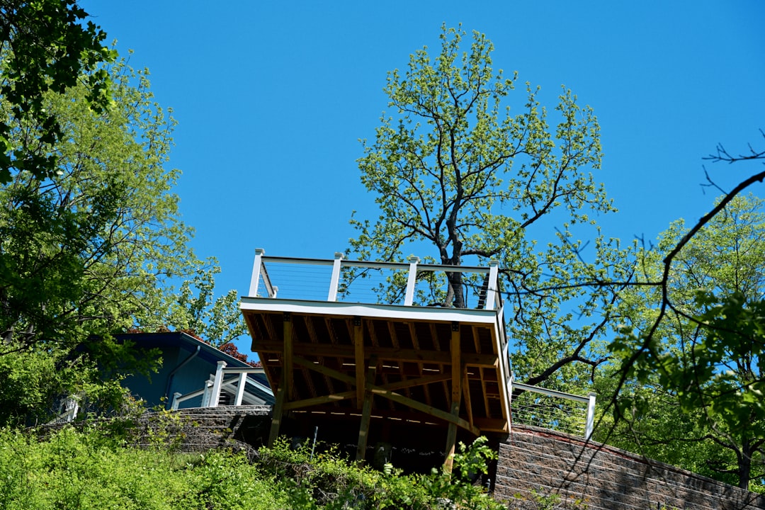 Elevated residential wood deck showing its support framing and cable railing
