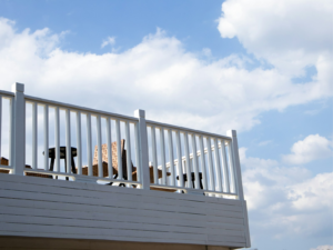Finished light-colored residential deck with outdoor chairs. Photo by 三山 on Unsplash.